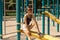 Cutie cheerful girl in sunglasses smiling on a playground