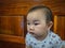 Cutie and handsome asian boy baby or infant make a face like interested