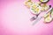 Cutlery with beautiful daffodils flowers and cake on pink background, top view, place for text. Easter food