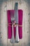 Cutlery - fork and knife on purple napkin in vintage stile