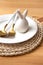 Cutlery golden spoon and fork lie on a white plate and ceramic easter bunny