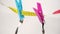 Cutlery hanging on a yellow centimeter, fixed with pink and blue clothespins
