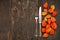 Cutlery on wooden table with Physalis (Chinese lanterns) autumnal Decorated