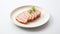 The cutlet is artistically sliced and elegantly presented on a rectangular ceramic plate with a distinct Japanese design