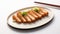 The cutlet is artistically sliced and elegantly presented on a rectangular ceramic plate with a distinct Japanese design