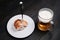 Cutlet with a fork and a mug of beer on a black background