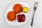 Cutlets in breading, pepper, ketchup in dish, fork on table. Top