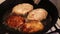 Cutlets for hamburgers are fried in a frying pan in the home kitchen