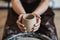 Cuts of product with wire. Craftsman hands making pottery bowl. Woman working on potter wheel. Family business shop