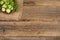 Cutted cucumbers with parsley on a brown plate and an old wooden