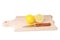 Cutted lemon and knife on wooden plank