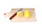 Cutted lemon and knife on wooden plank