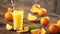 Cutted oranges and juice in glass on wooden background.