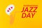 A cutted out of felt saxophone from which hearts flew out, on a yellow background. Flat lay. International Jazz Day