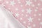 Cutted pink-white fabric with different stars pictures as background.