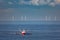 A cutter with lifted drag nets on the North sea with wind turbines