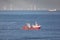 A cutter with lifted drag nets on the North sea with wind turbines