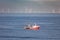 A cutter with lifted drag nets on the North sea with wind turbines in the background