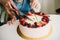 Cutting baby cake with strawberrie