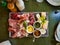 Cutting board based in charcuterie with jam variaties, antipasto, cheese  and sauces