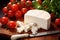 A cutting board with a block of cheese and cherry tomatoes, making a colorful and inviting snack