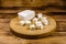 Cutting board with chopped feta cheese on a wooden table