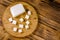 Cutting board with chopped feta cheese on a wooden table. Top view