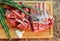 cutting board with fresh lamb ribs decorated with rosemary and g