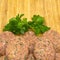 On cutting board homemade uncooked meatballs, kofte