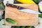 Cutting board, knife, fresh vegetables on wooden table. Top vie