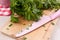 Cutting board with knife and parsley chopping