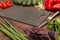 Cutting board, knife, vegetables greens for making salad on rustic table