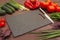 Cutting board, knife, vegetables greens for making salad on wooden table