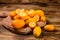 Cutting board with kumquat fruits on wooden table