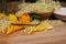 On a cutting board lie a sliced organic lemon and organic orange and a vanilla pod for the elderflower liqueur