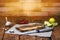 Cutting board and metal knife on the table. Handmade chopping board with lime pieces, garlic and spices