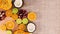 Cutting board with slices of oranges, limes, coconut, pumpkin and pomegranate appear on left side. Stop motion