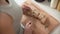 Cutting bread on wooden board by woman hands closeup