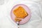 Cutting Cheese Bread On The Round Pink Plate White Background