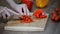 Cutting fresh red pepper. Fresh pepper on a wooden board. Cook cut vegetables with a knife.