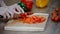 Cutting fresh red pepper. Fresh pepper on a wooden board. Cook cut vegetables with a knife.