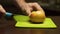 Cutting the halves of an apple in half sliced â€‹â€‹on a light green board.