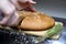 Cutting home made integral bread on wooden table