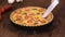 Cutting homemade quiche lorraine with chicken, mushrooms and cheese. French cuisine.