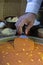 Cutting Kunafa or Kinafa, Arabic Sweets with Cheese for Ramadan a