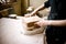 Cutting layers of clay pieces for sculpting in the potter`s workshop