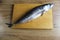 Cutting mackerel fish. mackerel fish carcass lying on a butcher board is a kind of serhu. cooking fish cutting. step 1