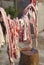 Cutting of meat hung during the slaughter in Malaga. Spain