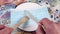 Cutting a medical mask with a wooden knife and fork on a white plate with a blue border.