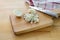 Cutting onions into small cubes with a kitchen knife on a wooden chopping board, selected focus, narrow depth of field